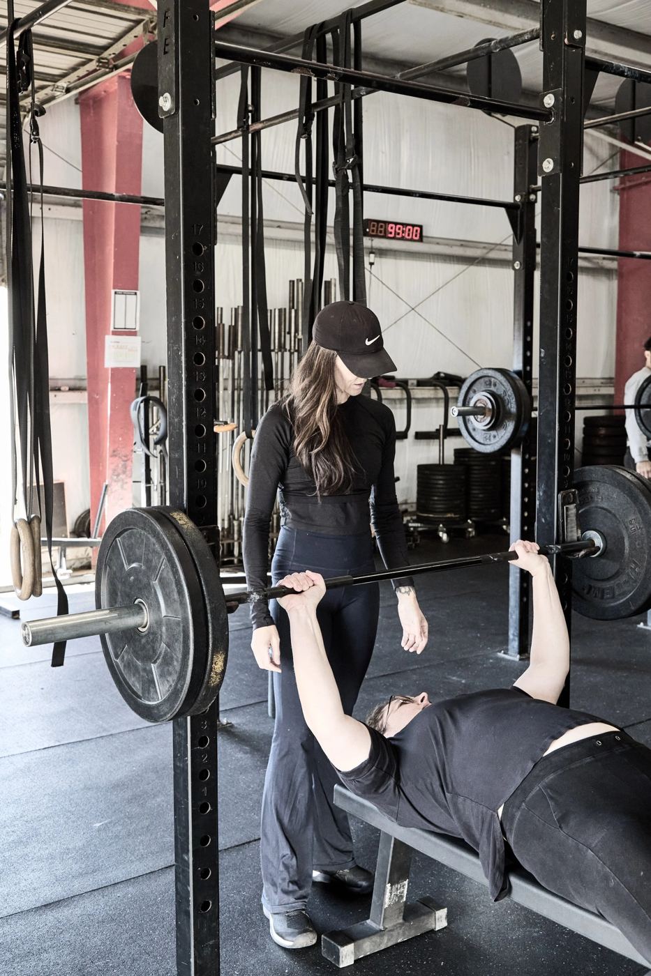 Erica spotting a client on the bench press